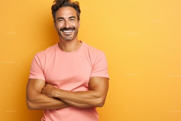 Medium shot portrait of a Brazilian man in his 40s in a pastel or soft colors background wearing a pair of leggings or tights