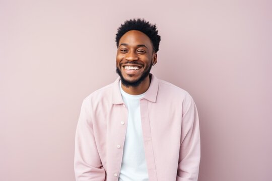 Portrait Of Handsome African American Man Smiling And Looking At Camera Isolated On Pink Background