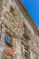 Fototapeta na wymiar sunlit rural streets, traditional houses lining up, the essence of historic Spain captured