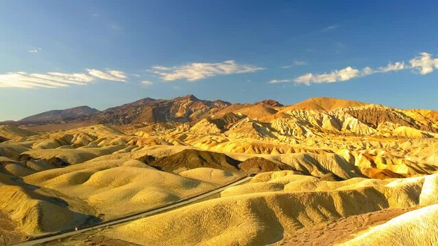 Aerial Descend Shot Of Scenic Rocky Landscape Against Sky, Drone Flying Over Rock Formations On Sunny Day - Death Valley, California