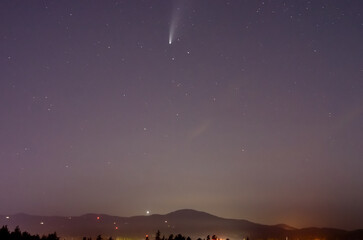 A comet passes by earth on a clear summer evening
