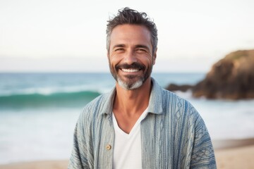 Medium shot portrait of a Brazilian man in his 40s in a beach background wearing a chic cardigan - Powered by Adobe