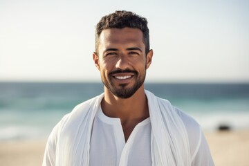 Portrait of smiling man in bathrobe standing at beach on a sunny day