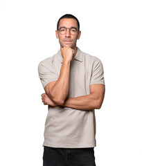 Happy young man smiling and making a gesture of trying to hear something