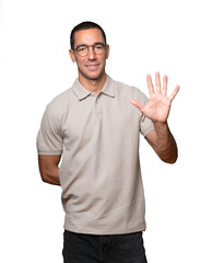 Young man making a number ten gesture