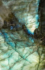 This is a macro photo of a colorful blue and green labradorite stone.  I used special lighting to bring out the iridescent colors and cracked mineral textures.