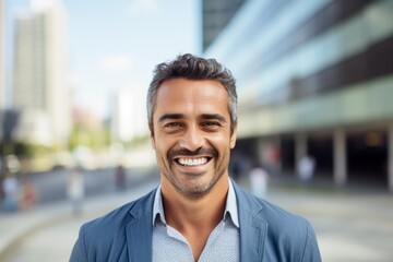 Obraz premium Portrait of a handsome middle-aged man smiling in the city