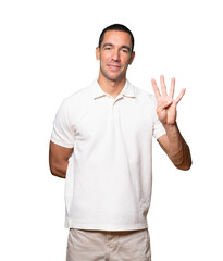 Young man making a number four gesture