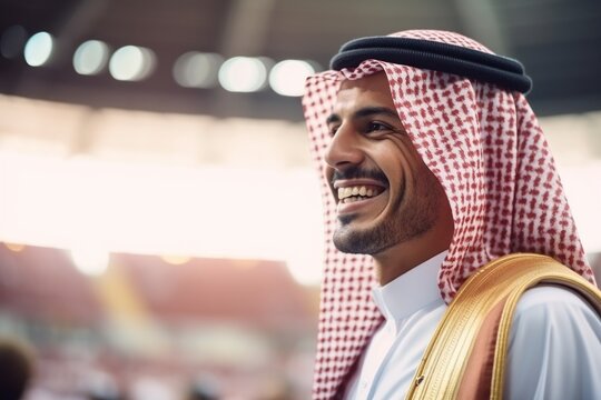 Portrait of smiling arabian businessman standing in the football stadium
