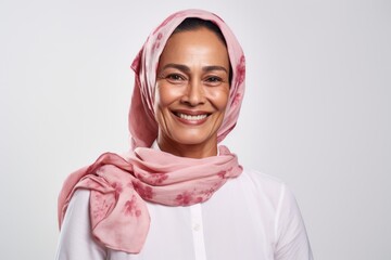 Portrait of a smiling muslim woman wearing hijab isolated on a white background