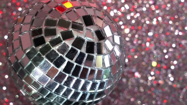 Glitterball in front of red blue bokeh disco background