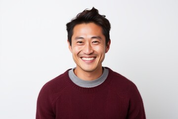 Fototapeta premium Portrait of a Chinese man in his 30s in a white background wearing a cozy sweater