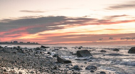 Aerial view of sea waves breaking beach during sunset