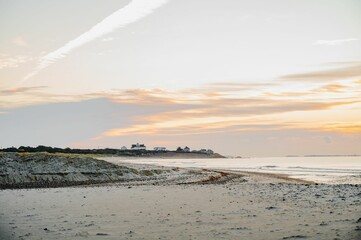 Aerial view of sea waves breaking beach during sunset