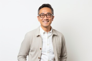 Handsome asian man with eyeglasses smiling at camera