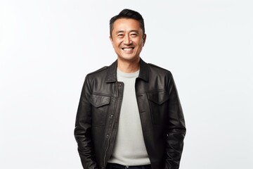 Portrait of smiling asian man in black leather jacket standing over white background