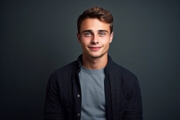 Obraz premium Portrait of a handsome young man on a dark background. Men's beauty, fashion.