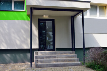 Staircase entrance to the building on the elevation stairs and roof with cantilever metal tubular...