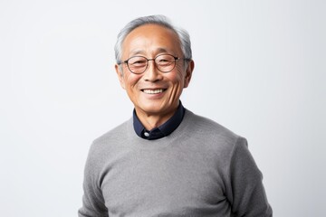 Portrait of happy asian senior man in grey sweater and glasses