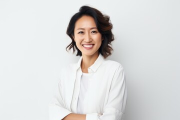 Portrait of a smiling asian businesswoman standing against white background