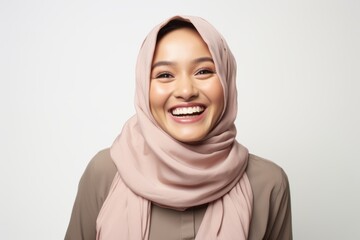Portrait of young beautiful asian muslim woman wearing hijab smiling