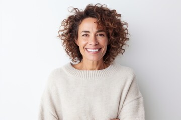 Portrait of a smiling woman with curly hair standing against white background