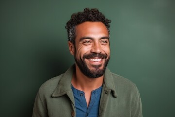 Portrait of a handsome african american man smiling and looking at camera against chalkboard