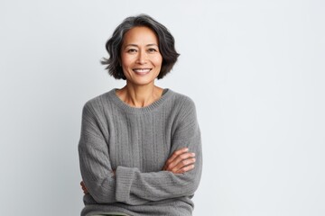 Fototapeta premium Portrait of a happy mature asian woman standing with arms crossed
