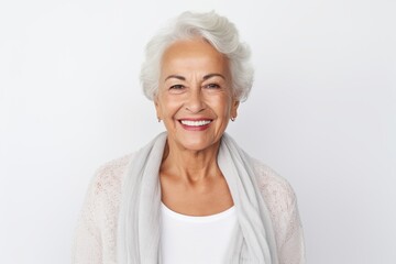Fototapeta na wymiar Portrait of happy senior woman with grey hair smiling at camera while standing against white background
