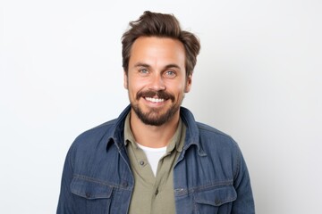 Obraz premium Portrait of a handsome young man smiling at the camera on a white background