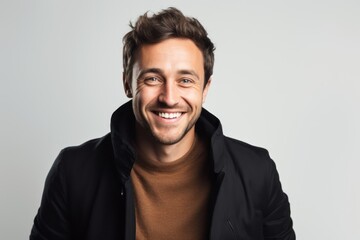 Fototapeta premium Portrait of a handsome young man smiling isolated on a white background