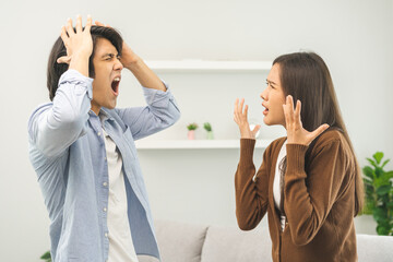 Asian young couple fight standing on white background, relationship in trouble. Different angry, use emotion shouting at each other. Argue husband has expression of disappointment and upset with wife. - obrazy, fototapety, plakaty