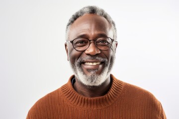 Portrait of a Nigerian man in his 50s in a white background wearing a chic cardigan