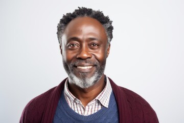Obraz premium Portrait of a Nigerian man in his 50s in a white background wearing a chic cardigan