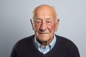 Obraz premium Portrait of a senior man with grey hair and freckles