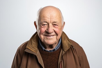Portrait of a senior man smiling at the camera on a white background