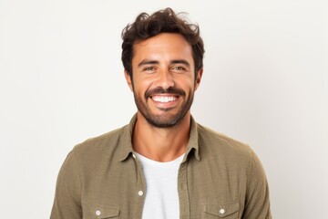 Fototapeta premium Portrait of a handsome man smiling at the camera against white background