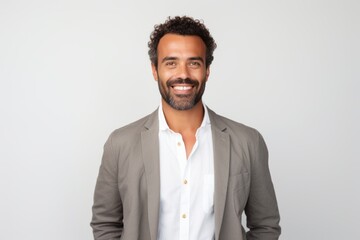 Portrait of a Brazilian man in his 30s in a white background wearing a chic cardigan