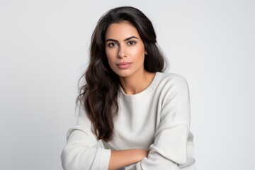 Obraz premium Portrait of a Saudi Arabian woman in her 30s in a white background wearing a cozy sweater
