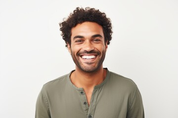Portrait of a happy young man smiling at camera over white background