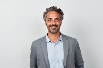 Portrait of a Saudi Arabian man in his 40s in a white background wearing a chic cardigan