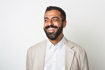 Portrait of a Saudi Arabian man in his 30s in a white background wearing a chic cardigan