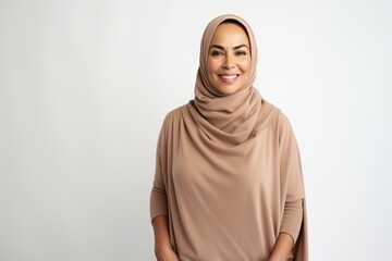 Portrait of happy muslim woman in hijab looking at camera and smiling