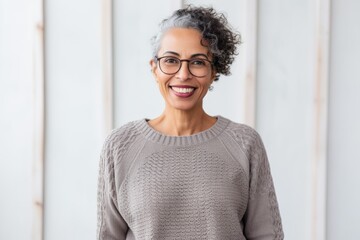 Portrait of smiling businesswoman in eyeglasses standing in office