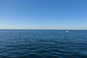 Scenic view of a tranquil bay with a boat floating in the distance