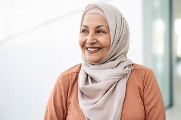 Portrait of smiling muslim businesswoman in hijab looking at camera