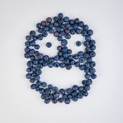 some blueberries are arranged in the shape of a smiley face