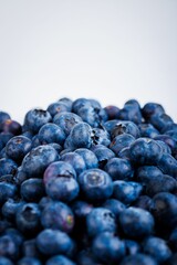 Selection of ripe blueberries, arranged on a white background