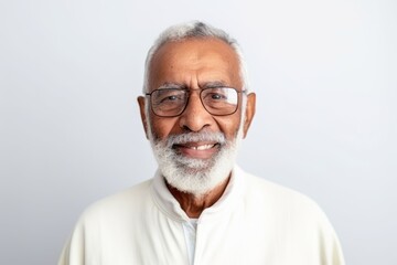 Obraz premium Portrait of a senior Indian man with eyeglasses on white background