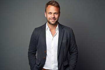 Portrait of a handsome man in a suit on a gray background